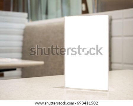 Restaurant table with mock up white sheets paper blank label menu frame acrylic stand display