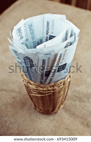russian banknotes in wicker vase