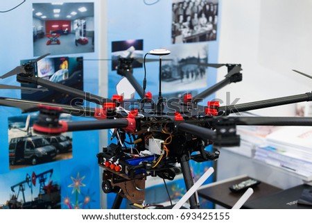 Black and red multicopter closeup. Drone with professional camera. Octocopter for filming