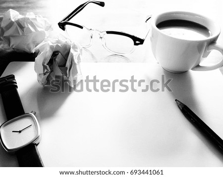 Businesses have both been successful and fail. The picture of fail work, glasses, paper, pencil, watch, a cup of coffee  and men hand gesture above wooden table.  black and white color
