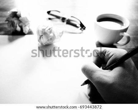 Businesses have both been successful and fail. The picture of fail work, glasses, paper, pencil, watch, a cup of coffee  and men hand gesture above wooden table. selective focus. black and white color