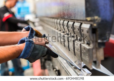 Sheet metal bending in factory Royalty-Free Stock Photo #693448198
