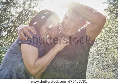 Man hugging woman in the rain 