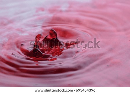 Pink water drop in clear water