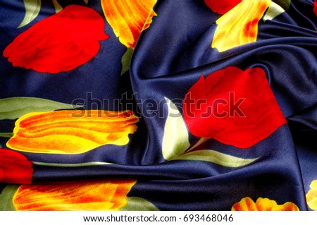 Texture, background, pattern. Cloth - silk women's handkerchief. Drawing Bright yellow red tulips on a blue background. Temple Flowers Purple Yellow Dancing Tulips Floral fabric
