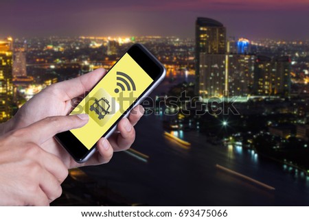 Hand of man using smartphone call taxi by application smartphone and wifi networking with cityscape background.