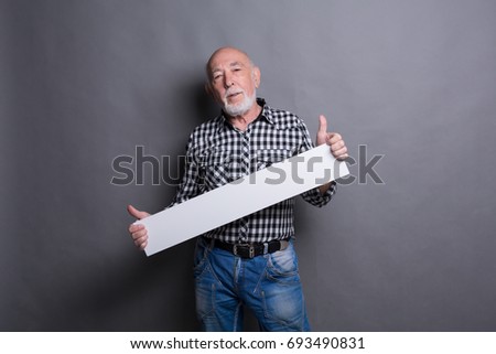 Senior man with blank white board. Mature male holding advertising sheet, copy space