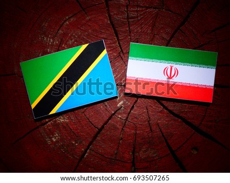 Tanzanian flag with Iranian flag on a tree stump isolated