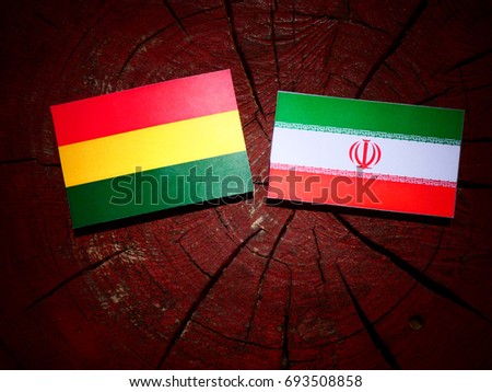 Bolivian flag with Iranian flag on a tree stump isolated