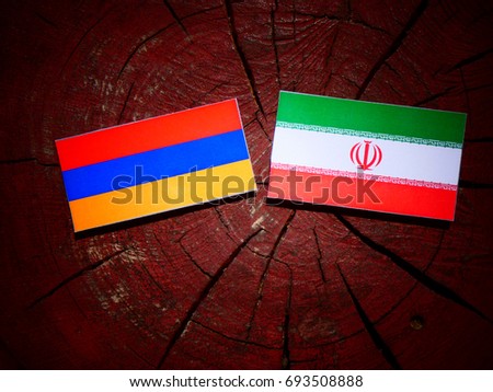 Armenian flag with Iranian flag on a tree stump isolated