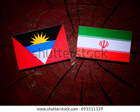 Antigua and Barbuda flag with Iranian flag on a tree stump isolated