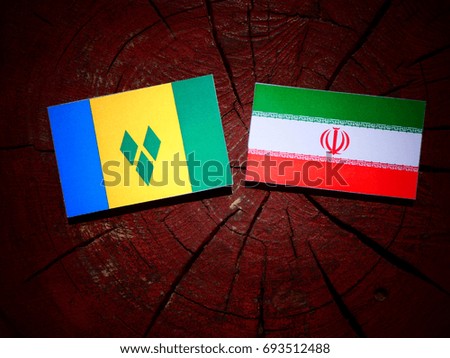 Saint Vincent and the Grenadines flag with Iranian flag on a tree stump isolated