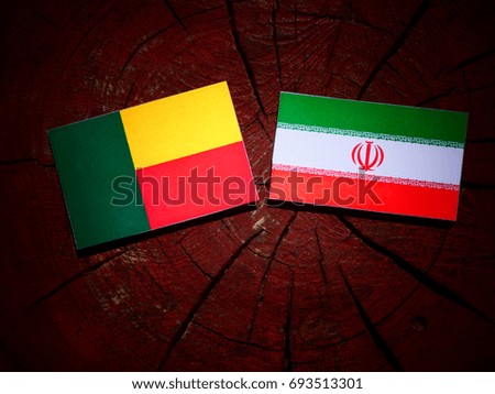 Benin flag with Iranian flag on a tree stump isolated