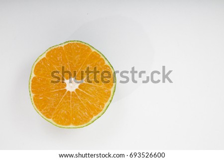 Close-up on beautiful half sliced tangerine, mandarine or clementine fruit on empty white background, copy space. Top view. Studio shot. Citrus fiber food advertisement poster. 