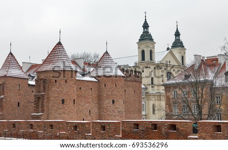 Winter cityscape with military medieval building Barbican and St Spirit and St Paul Pauline Church in Warsaw, Poland