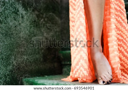 Ritual dance leg of young woman on stone stairs with moss