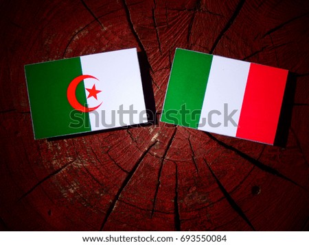 Algerian flag with Italian flag on a tree stump isolated