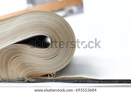 The old book, with dusty pages, curved edges