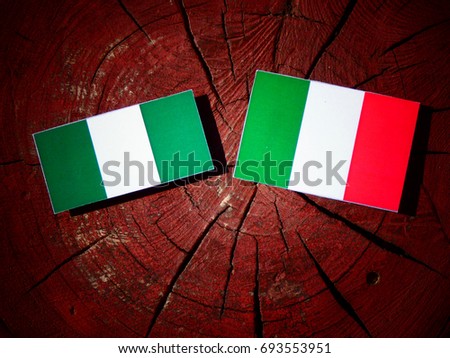 Nigerian flag with Italian flag on a tree stump isolated
