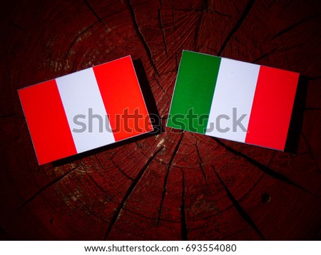Peruvian flag with Italian flag on a tree stump isolated