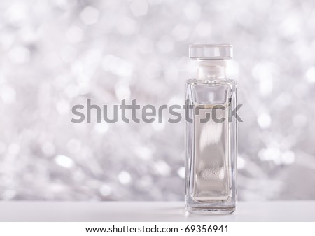 Perfume bottle on sparkling background