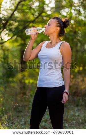 Young Girl Drinks Water After Training 