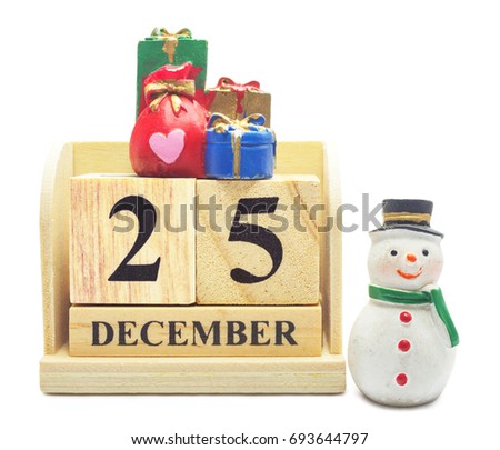 Wooden Calendar 25 DECEMBER with Christmas and New Year Decorate Snowman and gifbox isolated with clipping path, For Christmas and Happy New Year decoration celebrate Concept.
