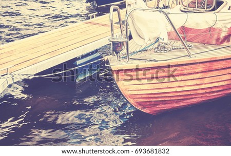 Vintage toned close up picture of an old wooden sailing boat.
