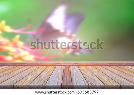 Perspective wood floor texture with blurry colored butterfly tree background.idea for product montage mockup