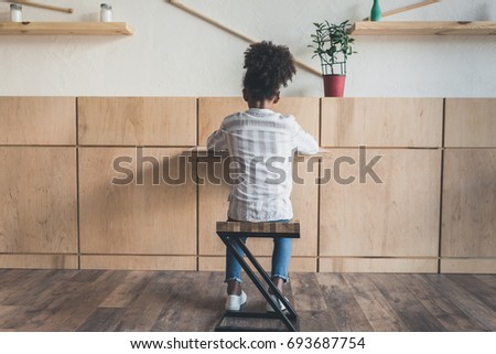 lonely african-american girl sitting in cafe