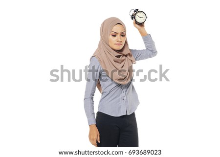 Portrait of young woman holding watch. isolated on a white background