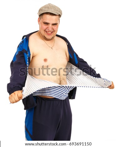 Guy is tearing up his shirt. Rips shirt. Angry man rips his shirt. Close-up portrait of a young fat man with a beard, tearing his shirt on his chest. Frock. Singlet. Striped Vest.