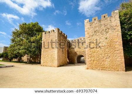 Walls and city gate to the old town of Lagos, Algarve Portugal Royalty-Free Stock Photo #693707074