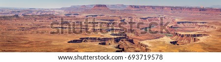 Canyonlands National Park is in Utah near Moab. It preserves a colorful landscape eroded into canyons, mesas, and buttes by the Colorado River, the Green River, and their respective tributaries. Royalty-Free Stock Photo #693719578