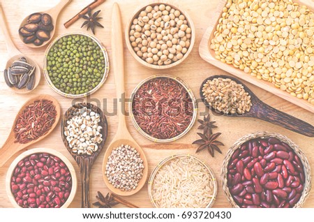 Various kinds of natural grain seeds consisted of green, red, black bean seeds, soybean, rice, wheat, millet, watermelon, and sunflower seeds in soft light blur filter