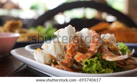 streamed crab paddle-leg with Thai-style seafood sauce Royalty-Free Stock Photo #693740617