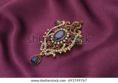 Vintage gold brooch with precious stones isolated on white Royalty-Free Stock Photo #693749767