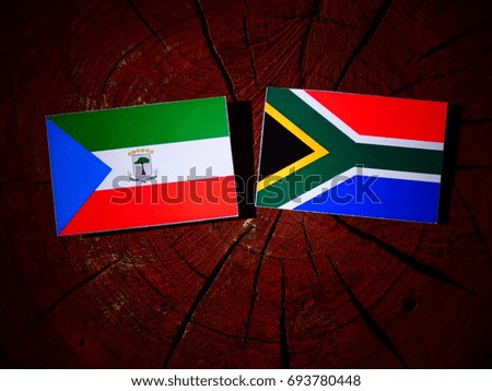 Equatorial Guinea flag with South African flag on a tree stump isolated