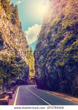 majestic mountain scenery. road in mountains, glowing in sunlight.  Romania- Carpathian Mountains. Bicaz Canyon ( Cheile Bicazului ) . Beauty in the world. retro vintage style. instagram filter