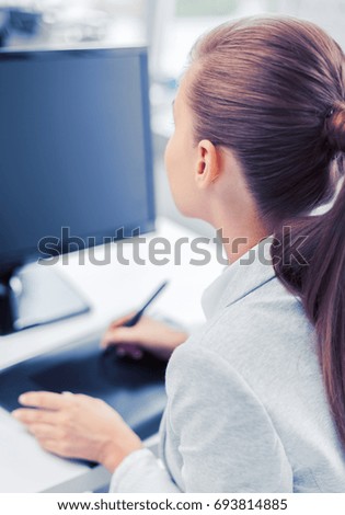business, office, school and education concept - smiling businesswoman with drawing tablet in office