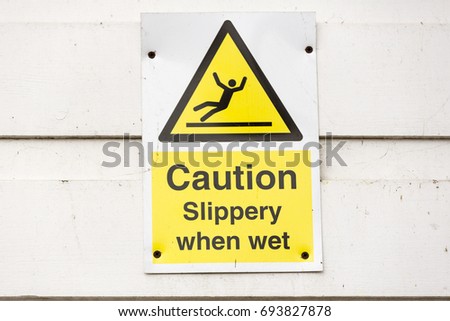 Yellow warning sign Caution Slippery When Wet 
