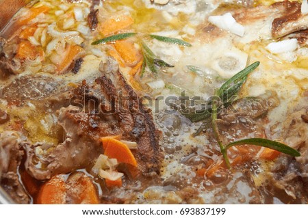 Delicious savory meat course stewed with vegetables and rosemary greenery
