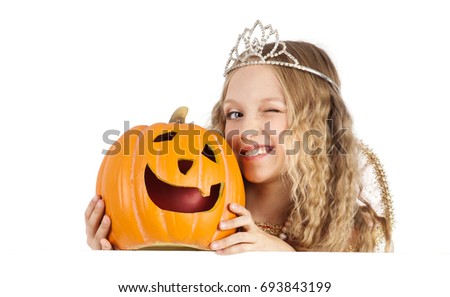 Beautiful Little Blonde Girl in a Costum of Princess with Pumpkin Winking and Holding the Banner of Halloween or Carnival Party