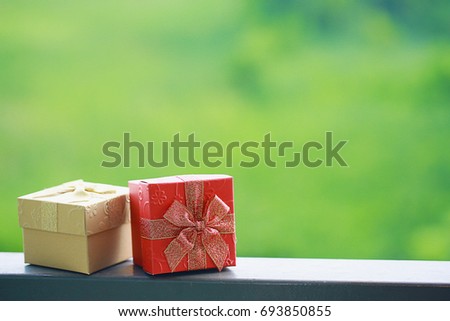 A gift box, red box place on wood. happy new year and xmas in next year 2022 concept. image for background, wallpaper and copy space.