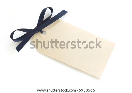 Blank gift tag tied with blue satin ribbon bow.  Casting soft shadow on white surface.