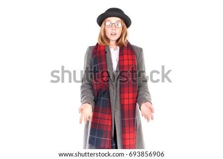 Portrait of teenage hispter girl wearing gray overcoat and black hat isolated on white