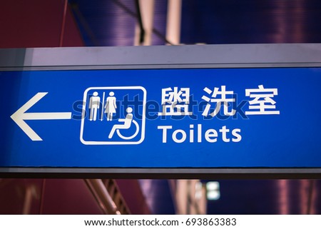 Toilet sign and icon in English and Chinese at airport