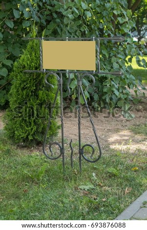 Forged signboards on the background of grass, without the inscription