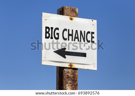 Big chance word and arrow signpost on clear sky background. Motivational sign.