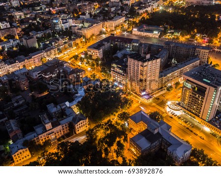 Panoramic aerial view of night city Kharkiv, Ukraine. Fairy evening orange street lights. Fantastic night cityscape. Drone photography from 100 meters height.